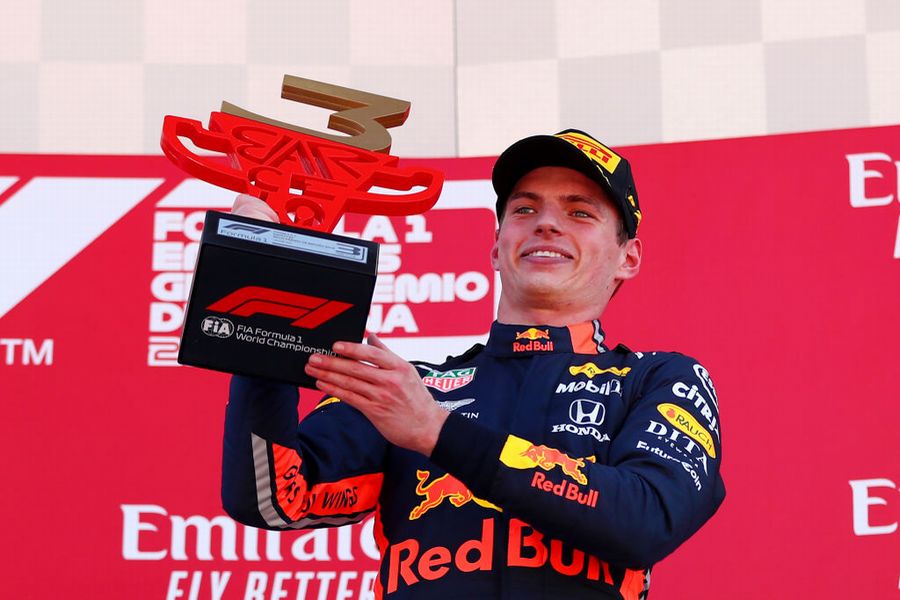 Max Verstappen celebrate on the podium with the trophy