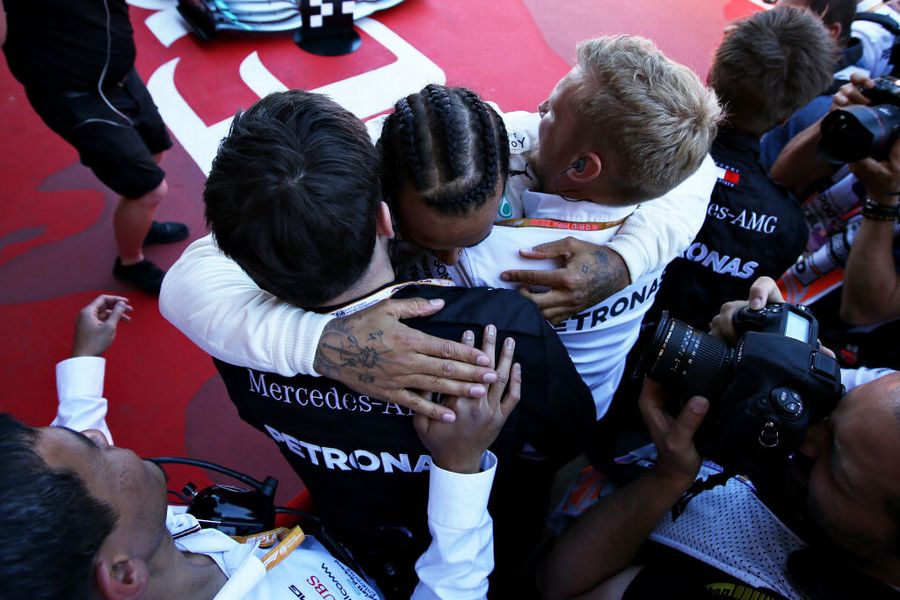 Race winner Lewis Hamilton cerebrates in parc ferme with the team