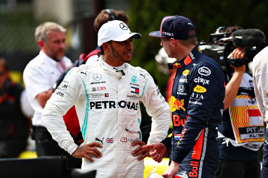 Pole sitter Lewis Hamilton talks with Max Verstappen in parc ferme
