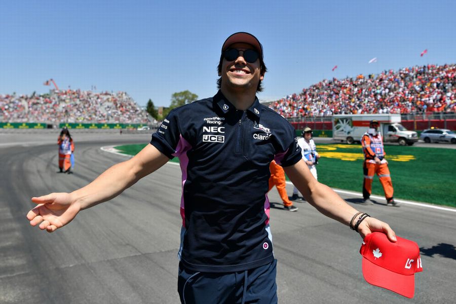 Lance Stroll waves to the crowd on the drivers parade