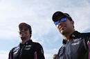 Sergio Perez and Lance Stroll smile in the Paddock
