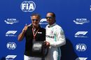 Lewis Hamilton receives the Pirelli Pole award from Jean Alesi