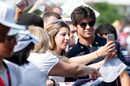 Lance Stroll poses for a photo with fans