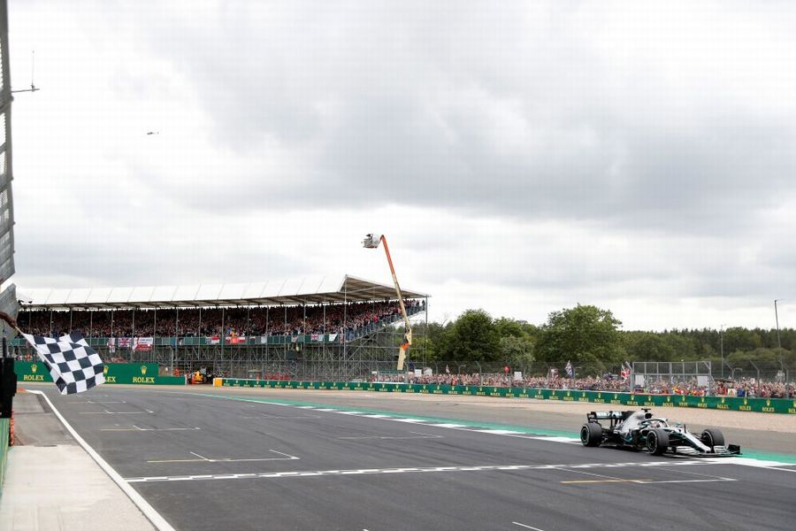 Race winner Lewis Hamilton crosses the finish line