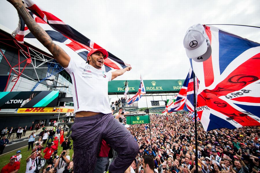 Race winner Lewis Hamilton celebrates with fans