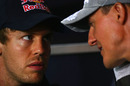 Sebastian Vettel and Michael Schumacher chat during a press conference