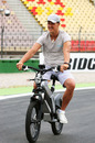 Michael Schumacher rides his bike around the circuit