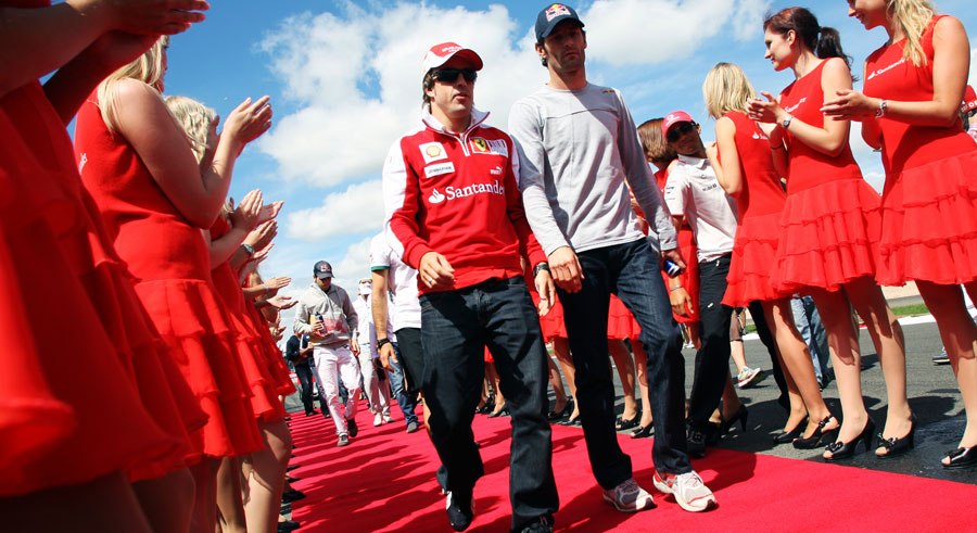 Fernando Alonso and Mark Webber head to the drivers' parade as Lewis Hamilton jumps the queue