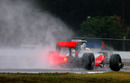 Spray flies from the back of Lewis Hamilton's McLaren