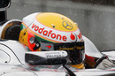 Rain falls on Lewis Hamilton