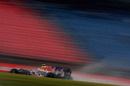 A rooster tail of spray comes from the back of Sebastian Vettel's Red Bull