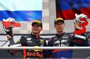 Race winner Max Verstappen and Daniil Kvyat celebrate on the podium with the trophy