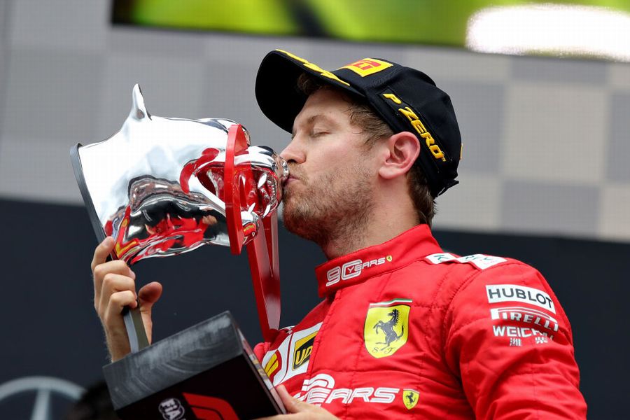 Sebastian Vettel celebrate on the podium with the trophy