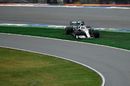 Lewis Hamilton crosses the grass at the pitlane entry