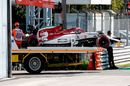 The damaged car of Kimi Raikkonen is transported off the circuit following a crash