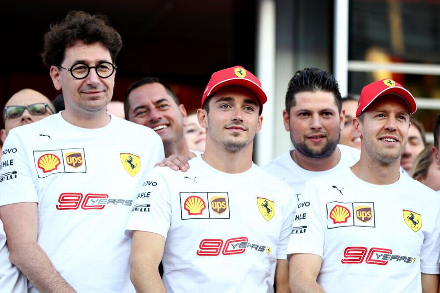 Sebastian Vettel, Charles Leclerc, Mattia Binotto and the Ferrari team pose for a photo in 90th anniversary t-shirts