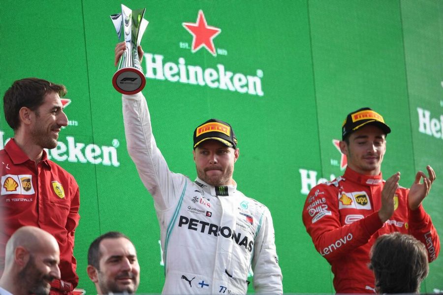 Valtteri Bottas celebrate on the podium with the trophy