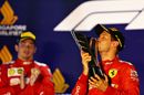 Race winner Sebastian Vettel celebrate on the podium with the trophy