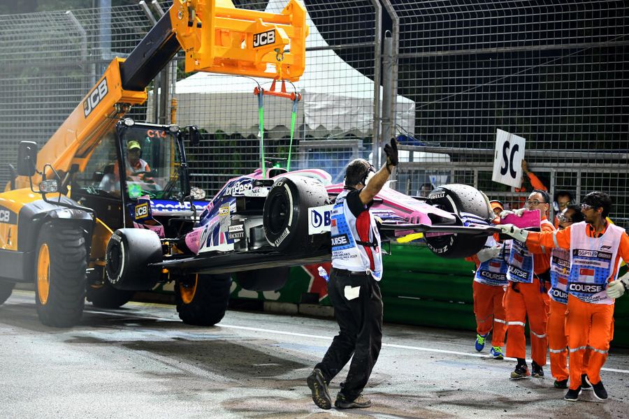 The car of Sergio Perez is removed from the circuit after he retired