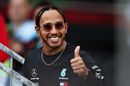 Lewis Hamilton gives a thumbs up on his way to the fan stage