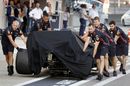 Red Bull Racing's mechanics push the crashed car of Alexander Albon in the pits