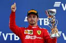 Charles Leclerc celebrate on the podium with the trophy