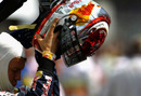 Sebastian Vettel takes off his new helmet after qualifying