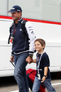 Rubens Barrichello arrives at the circuit with his son Fernando on Sunday
