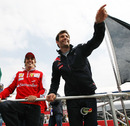 Fernando Alonso and Mark Webber wave to the crowd during the drivers' parade