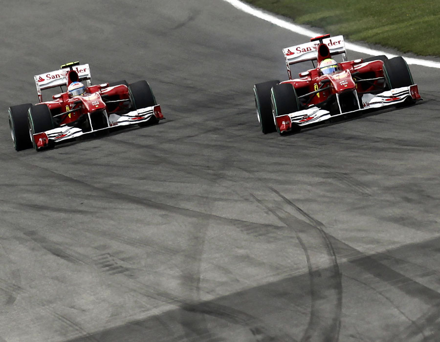 Felipe Massa prepares to move aside to let Fernando Alonso past