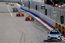The safety car leads Sebastian Vettel on track