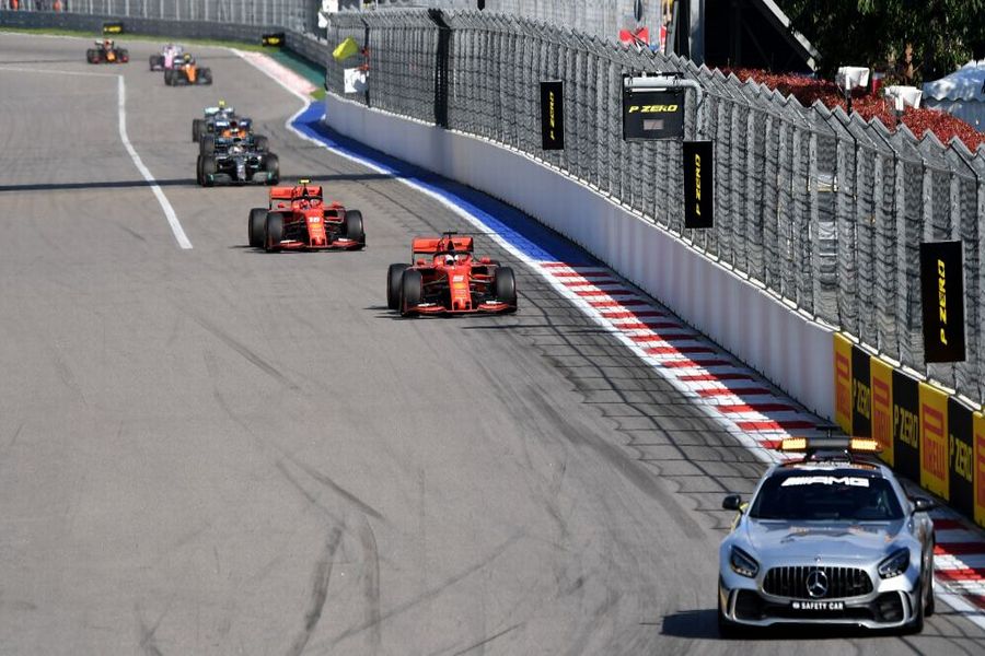 The safety car leads Sebastian Vettel on track