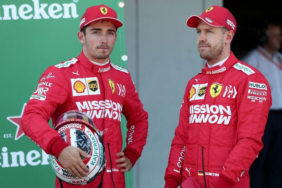 Pole sitter Sebastian Vettel stands with Charles Leclerc in parc ferme