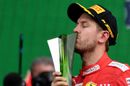 Sebastian Vettel celebrate on the podium with the trophy