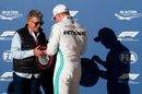 Valtteri Bottas signs a tire after taking pole position