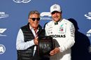 Pole sitter Valtteri Bottas is presented with the Pirelli Pole Position trophy by Mario Andretti in parc ferme