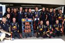 Red Bull Racing team pose for a photo to commemorate the 100th Formula One race of Max Verstappen