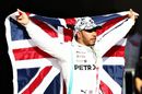 2019 Formula One World Drivers Champion Lewis Hamilton celebrates in parc ferme