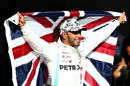 2019 Formula One World Drivers Champion Lewis Hamilton celebrates in parc ferme