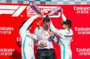 Lewis Hamilton, James Allison and Valterri Bottas celebrate on the podium with the champagne