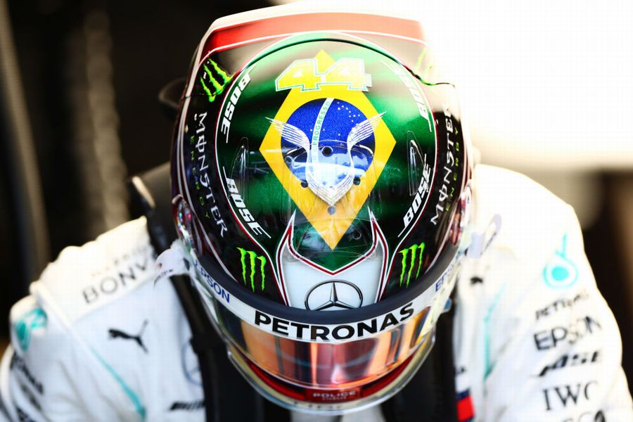 Lewis Hamilton prepares to drive in the garage