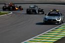 The safety car leads Lewis Hamilton on track