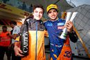 Carlos Sainz Jr celebrates after later being awarded third place with Lando Norris