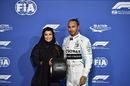 Aseel Al-Hamad presents the pole postion trophy to Lewis Hamilton