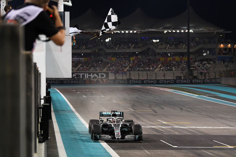 Race winner Lewis Hamilton takes the chequered flag