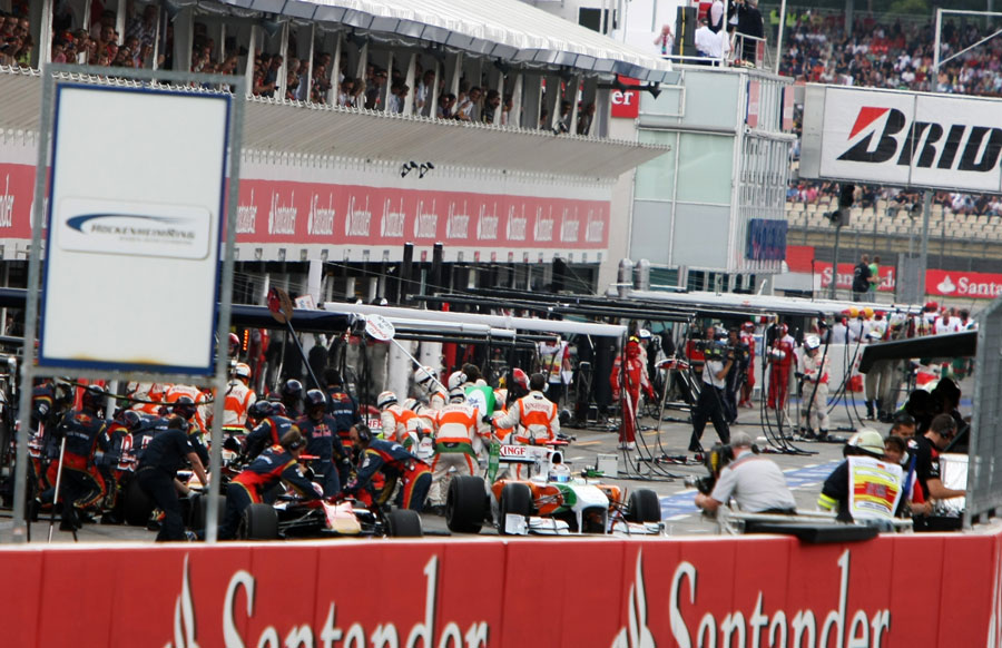 Force India completes a pit stop as Sebastien Buemi retires
