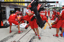 The Ferrari team practices a pit stop