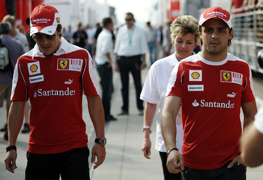 Fernando Alonso and Felipe Massa walk the paddock