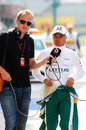 Heikki Kovalinen is interviewed on his way to the Lotus garage