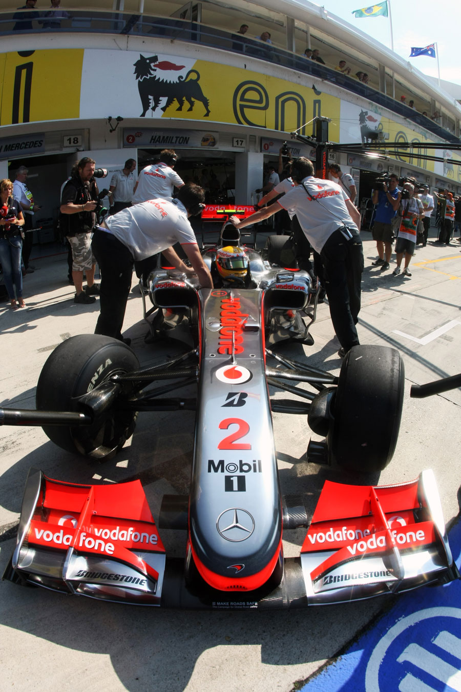 Lewis Hamilton is pushed into the McLaren garage
